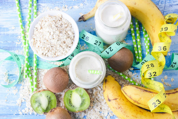 kiwi Banana smoothie with honey and oats on a wooden table.