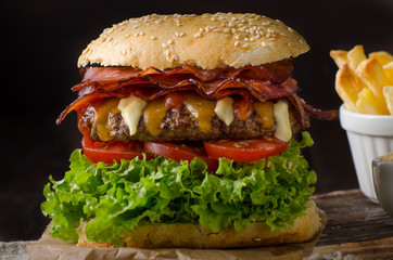 Homemade bacon burger with lettuce and cheddar