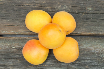 Naklejka na ściany i meble natural, organic apricot on a wooden background