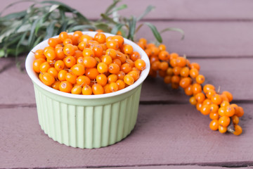 ripe sea buckthorn on a wooden background