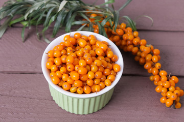 ripe sea buckthorn on a wooden background