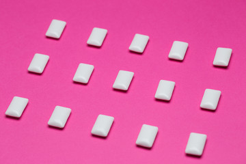 Fototapeta na wymiar Chewing gum close up on a pink background