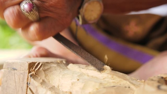 Woodcarver Doing Carving with Sharp Tools on Wooden Workpiece. Traditional Balinese Statuette Making Process. 4K. Bali, Indonesia.