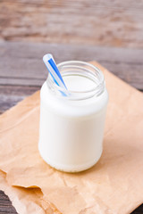 milk with cookies on a wooden background