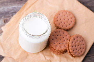 milk with cookies on a wooden background