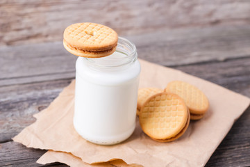 milk with cookies on a wooden background
