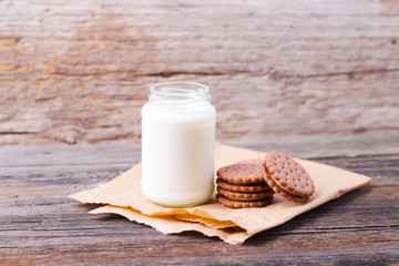 milk with cookies on a wooden background
