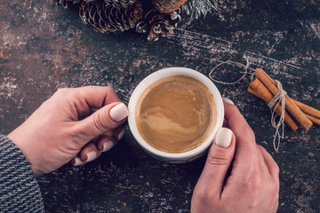 Woman holding hot cup of coffee. Toned photo