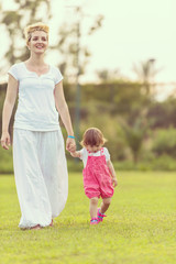 mother and little daughter playing at backyard