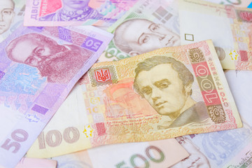 Close up on pile of many bank notes from various countries from around the world. U.S., German, Swiss, Canadian, Brazilian, Vietnamese, Mexican. Many countries represented in currency. 