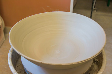 Artist potter in the workshop sculpting ceramic vase. Small artistic craftsmen business concept. 