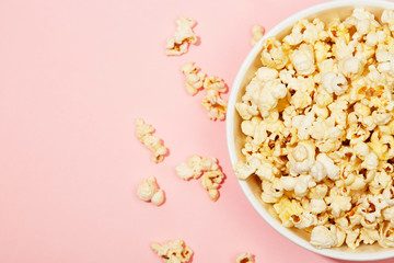 Full of popcorn in bowl on color background