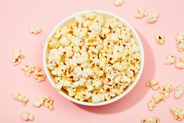 Full of popcorn in bowl on color background