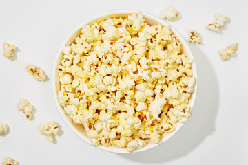Full of popcorn in bowl on white background
