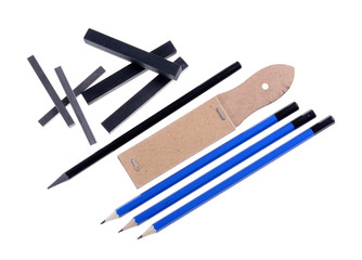 black chalk pastels arranged,set for black pencils and sandpaper isolated white background, graphics tools
