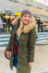 Portrait of attractive happy plus size young model in parka jacket casual style walk at city at winter day . Life of xl woman  