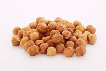 A pile of hazelnuts at white background	