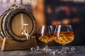 Two glasses of Cognac with ice cubes