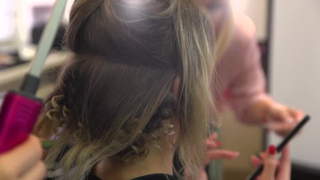 Curling hair styling and makeup for women with smartphone