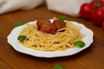 Spaghetti pasta meatballs with tomato sauce, basil, herbs Parmesan cheese on wooden background. Selective focus