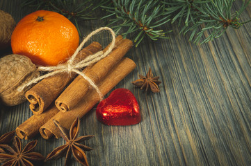 Bunch of cinnamon orange anise next to pine branch