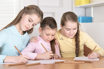 Close-up portrait of beautiful girls doing homework