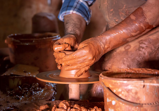 Professional potter making bowl in pottery workshop, studio.