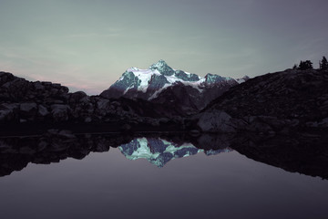 Mount Shuksan in autumn reflected at sunset