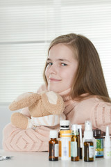 Obraz na płótnie Canvas Close-up portrait of cute little girl taking medicine