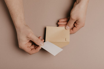 Hand holding blank envelope and letter mockup