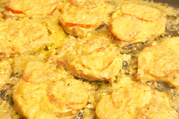 Baked meat with tomatoes and cheese, background texture close up