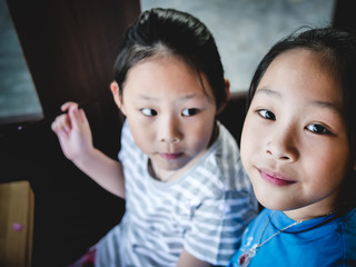 Happy Asian children enjoy their drink in coffee shop, lifestyle concept.