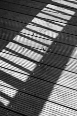 shadow of a railing on wood