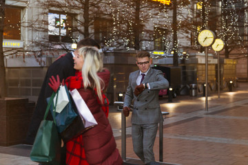 Fototapeta premium The happy young couple hugging after the good shopping outdoor and smiling