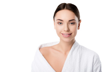 attractive smiling woman in bathrobe looking at camera isolated on white