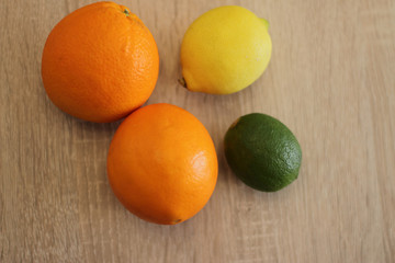 orange lime and lemon on wooden table