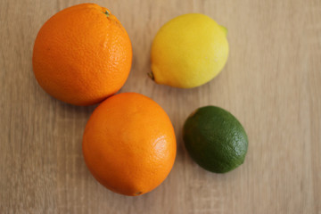 orange lime and lemon on wooden table