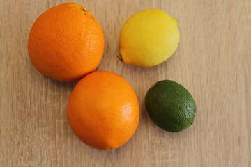 orange lime and lemon on wooden table