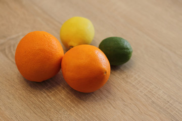 orange lime and lemon on wooden table