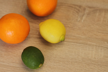 orange lime and lemon on wooden table © Olga