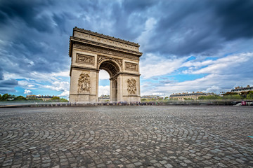 Dark Clouds coming over the Arc de Triomphe in Paris, France - obrazy, fototapety, plakaty