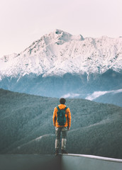 Man traveler standing alone enjoying mountains view active adventure lifestyle vacations travel outdoor solitude and silence