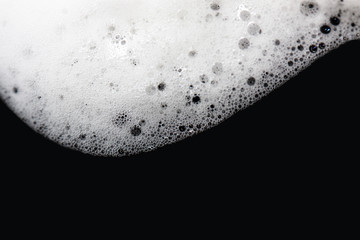 Foam bubbles abstract black background. Detergent.