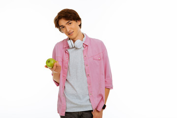 Nice young teenager holding a green apple