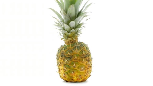 Fresh pineapple isolated rotating on white background. Ripe whole pineapple isolated on white. Exotic tropical tasty fruit.