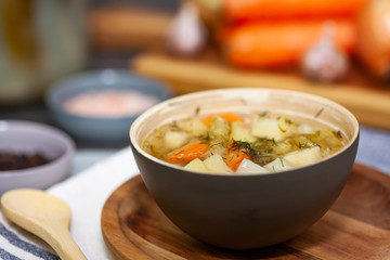Cucumber soup made of pickled cucumbers with vegetables in the background