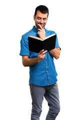 Handsome man with blue shirt reading a book