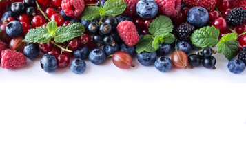Naklejka na ściany i meble Mix fruits berries isolated on white background. Ripe currants, raspberries, blueberries, gooseberrie, blackberries with a mint leaf. Top view.
