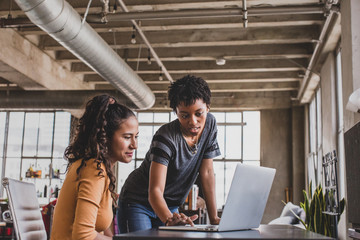 Young adults studying together in a loft apartment