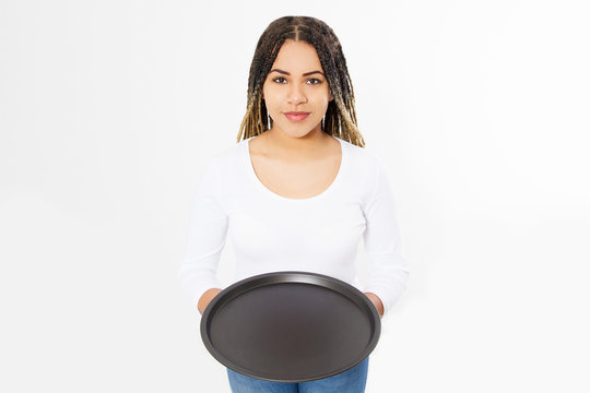 Young attractive woman holding empty pizza tray isolated on white background. Copy space and mock up. Blank template background.
